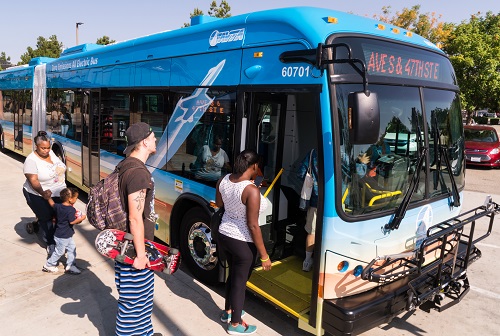People board a bus.